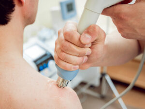 man receiving tissue regenerative therapy (TRT) for shoulder pain